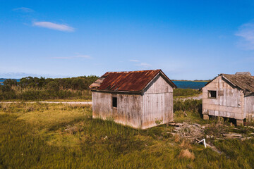 This is a view of an abandoned oyster house along the shores of Chincoteague Bay on George Island Landing, a declined oyster, clam, and crab fishing village in Maryland.