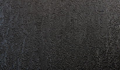 Black texture background. The dark embossed background.