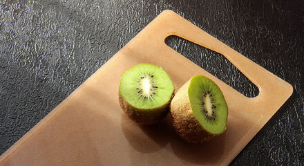 Kiwi slices on the Board on a black background.
