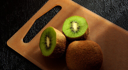 Kiwi slices on the Board on a black background.