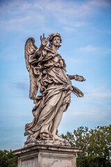 Statue of an angel against the blue sky on the bridge of Sant'angelo in Rome, Italy