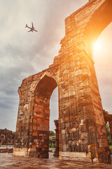 Airplane in sky above Qutb Minar Complex