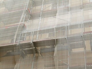 Covered with netting and scaffolded building detail under renovation in Budapest, Hungary