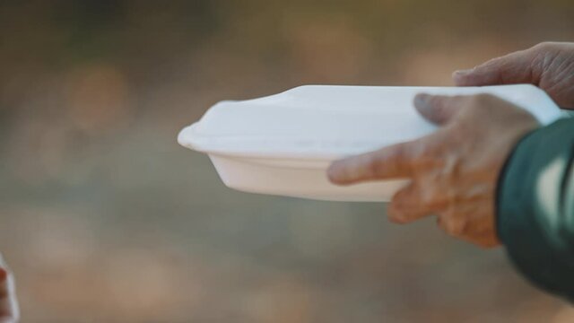 woman volunteer help feed the homeless with free meal. Close-Up. . High quality 4k footage