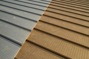 Fototapeta premium Metallic aluminum sheets in steel and gold color on the roof. close-up
