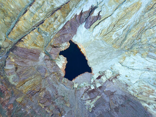 Aerial view of a copper mine near bisbee arizona. The bottom of the canyon with a lake of dark water can be seen