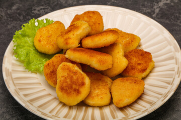 Fried chicken nuggets served salad leaves