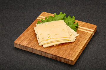 Sliced yellow cheese over board