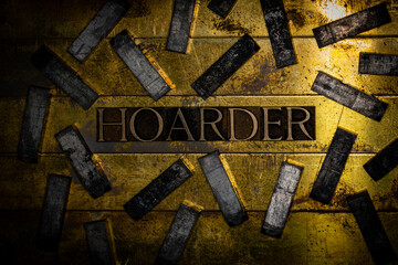 Hoarder text formed with real authentic typeset letters on vintage textured silver grunge copper and gold background