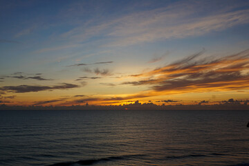 A blue, yellow, and orange sunrise over the Atlantic Ocean