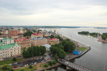 Obraz premium Top view of the beautiful old town, water and cozy colored houses, Russia, Vyborg. 