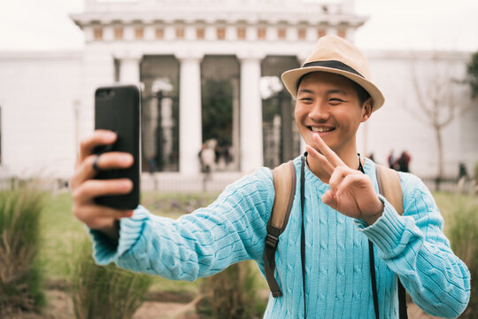 Asian Tourist Taking A Selfie With Mobile Phone.