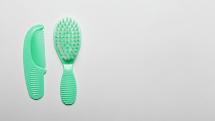 Green baby comb on white background with copy space