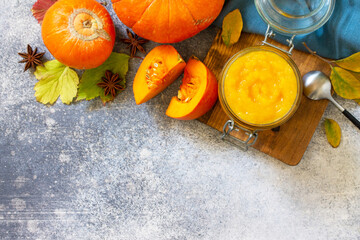 Autumn pumpkin meals for thanksgiving day. Pumpkin Puree on a slate background. Top view flat lay background with copy space.