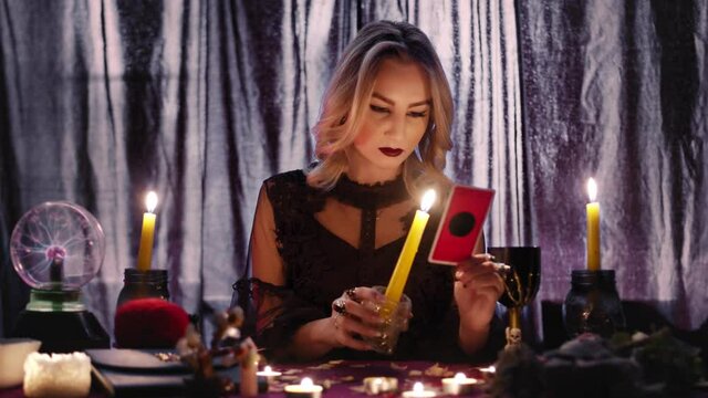 Fortune teller tarot reader looking at card and reading future and fortune