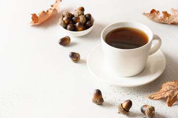 Acorn coffee substitute on white table. Close up. Space for text.