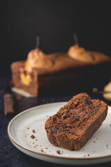 Homemade vegan chocolate cake with poached pears served on plate. Autumn cake.