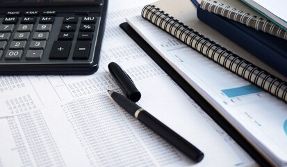 Business documents on an office desk with a calculator and pencil as a business concept of a workspace. With cloud exposure