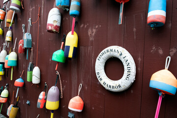 Lobster buoys on exterior wall with life saver tube
