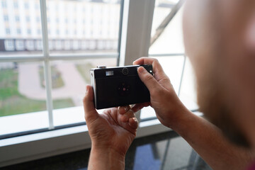 person taking a picture with an old camera