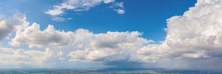 White clouds on a background of blue sky. Panorama