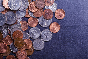 American coins and us dollars on a black table