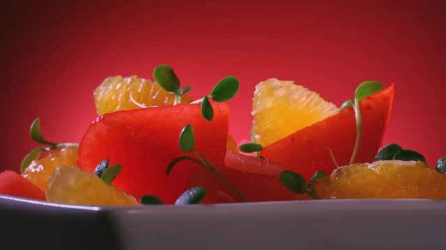 Fresh watermelon, orange, and microgreen salad with salt and sugar sprinkle