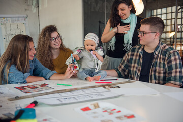 Group of designers with adorable baby girl