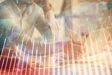 Multi exposure of man and woman working together and financial chart hologram. Business concept. Computer background.