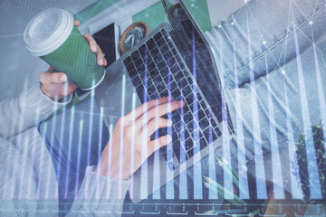 Double exposure of woman hands typing on computer and forex chart hologram drawing. Stock market invest concept.