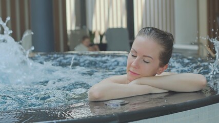 Woman relaxing in hot tube, Resting in whirlpool water in wellness spa resort. 