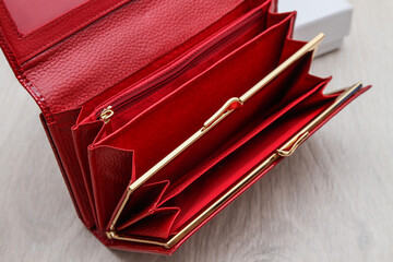 open empty red women wallet on gray background