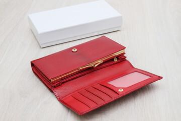 open empty red women wallet on gray background