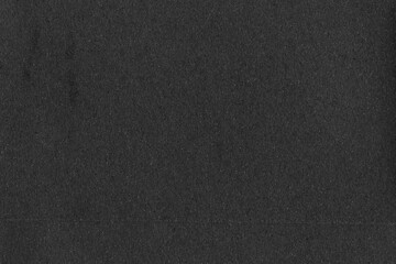 A black vintage rough sheet of carton. Recycled environmentally friendly cardboard paper texture. Simple gray minimalist papercraft background.
