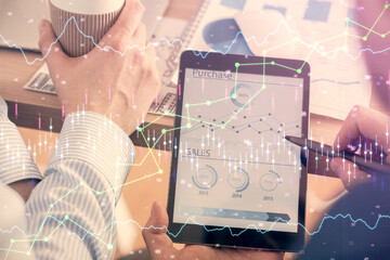 Double exposure of man's hands holding and using a phone and financial chart drawing. Market analysis concept.