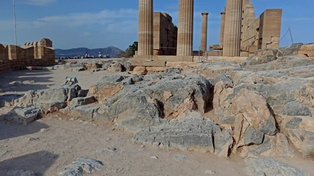 Rhodes, Greece: Pan shot of the ruins of ancient citadel / acropolis on a steep cliff with mediterranean sea views. Its famous touristic main attraction in Lindos