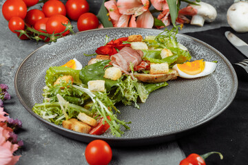 caesar salad on a gray plate with decor and copyspace