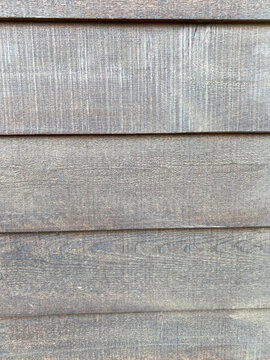 Lasiertes graues Holz einer Fassade grob gehobelt