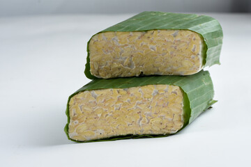 tempeh Indonesian traditional food made from fermented soybeans. They are usually wrapped in banana leaves.