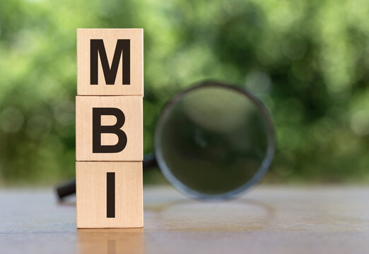 Text MBI on wooden cubes on a wooden background