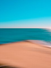 Fototapeta na wymiar Abstract blurred tropical seascape of warm-colored beach