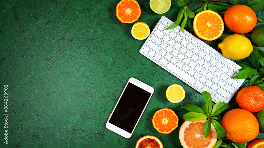 Wall mural health food theme background workspace with citrus fruit on dark green textured background. top view
