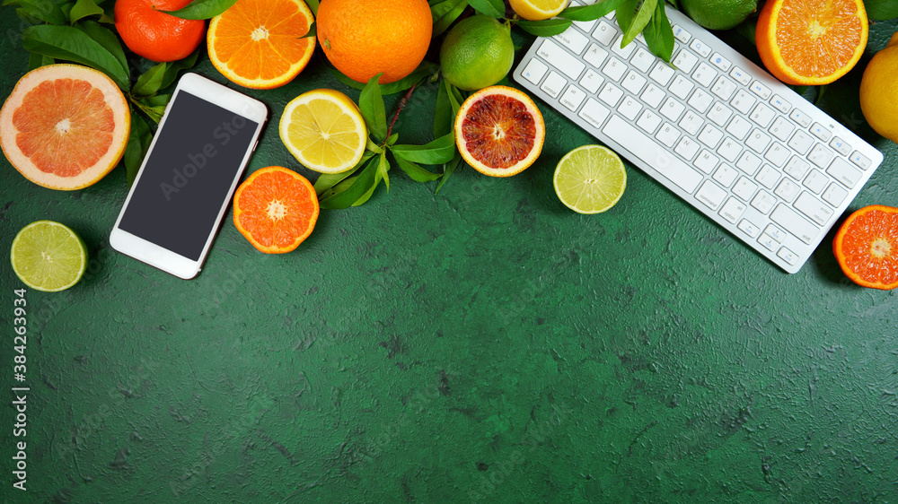 Wall mural health food theme background workspace with citrus fruit on dark green textured background. top view