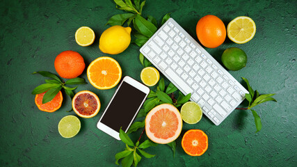 Health food theme background workspace with citrus fruit on dark green textured background. Top view blog hero header creative composition flat lay with negative copy space.