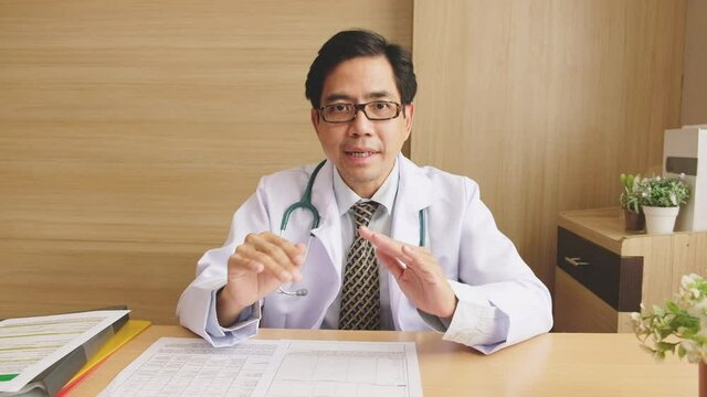 POV Asian man doctor talking with patient via video call conference, telehealth or telemedicine concept