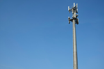 Mobile phone tower against blue sky