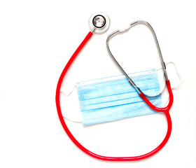 Medical red stethoscope and blue mask on white background. Copy space.