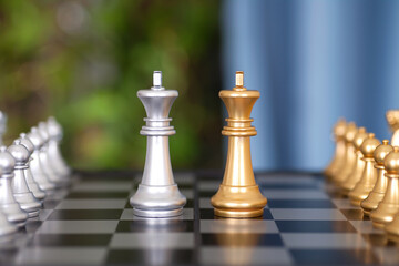 Two chess pieces on the chess board and two king pieces facing each other in close quarters