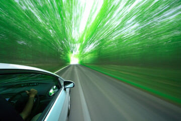 Obraz na płótnie Canvas 新緑の中を走るハイブリッドカー