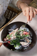 Young pretty woman is eating salad in a fancy restaurant, beautiful, neat, elegant hands, close up